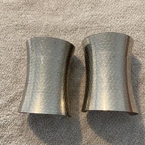Silver pair of arm cuffs